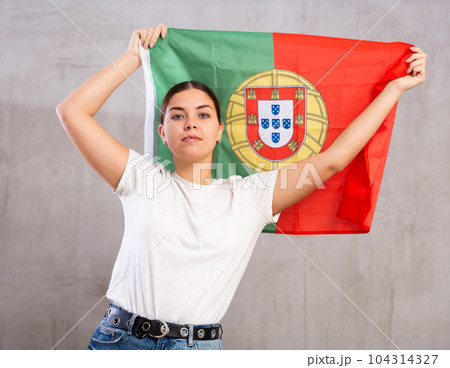 Attractive female football fan holding Portugal flag Attractive female football fan holding Portugal flag 104314327