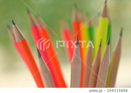 group of colourful sharp pencil on blur green nature background with bokeh 104315698