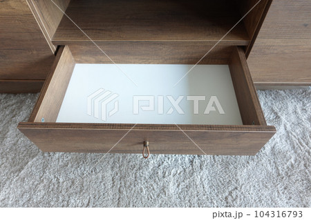 top view of a opened empty drawer  104316793