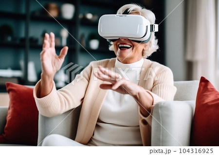Senior mature female having fun with virtual reality glasses. Old woman using new headset goggles trends technology 104316925