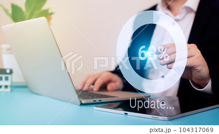 Man using laptop at the table. update the operating system to a newer one. Systems engineer and programmer. Man using laptop at the table. update the operating system to a newer one. Systems engineer and programmer. 104317069