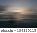 Sunset in the ocean in a blur of motion 104320115