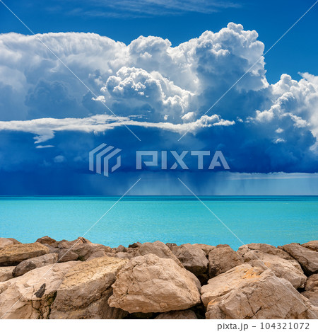 Breakwater and Seascape with Storm Clouds and Torrential Rain 104321072