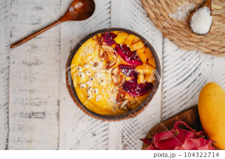 Mango Fruit Smoothie Bowl in Coconut Shell Cup 104322714