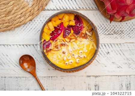 Mango Fruit Smoothie Bowl in Coconut Shell Cup Mango Fruit Smoothie Bowl in Coconut Shell Cup 104322715