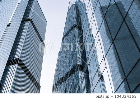 Business skyscrapers and office business center building architecture in perspective on blue sky. Economy, exchange, finance concept. Business skyscrapers and office business center building architecture in perspective on blue sky. Economy, exchange, finance concept. 104324365