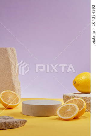 Against the purple background, fresh lemon and lemon slices decorated with blocks of stone and empty podium. Lemon is a versatile fruit that is responsible for several health benefits Against the purple background, fresh lemon and lemon slices decorated with blocks of stone and empty podium. Lemon is a versatile fruit that is responsible for several health benefits 104324592