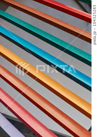 Multicolored wooden rails, lilac red orange yellow blue green wood planks abstract background. Multicolored wooden rails, lilac red orange yellow blue green wood planks abstract background. 104325265