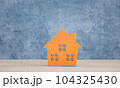 orange wood home model on blue background 104325430