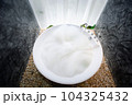circle bathtub full with bath foam in bathroom 104325432
