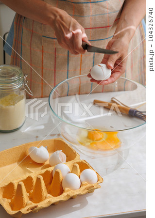 top view of woman beating eggs for an omelette or pie. Cook delicious and healthy food  104326740