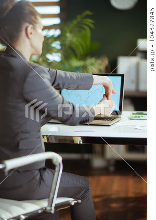 modern business woman in modern green office stretching hand 104327845