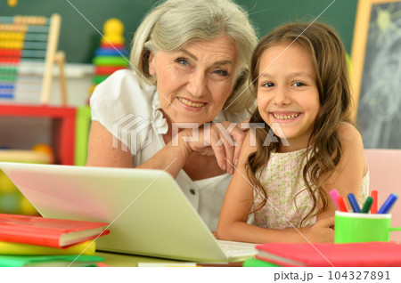 Close up portrait of happy grandmother and granddaughter Close up portrait of happy grandmother and granddaughter 104327891