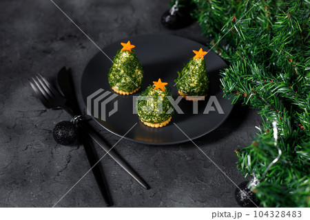 Holiday appetizer in form of christmas tree Holiday appetizer in form of christmas tree 104328483