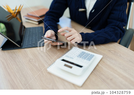 financial, Planning, Marketing and Accounting, portrait of Asian employee checking financial statements using and calculator, tablet computer and smart phone at work. 104328759