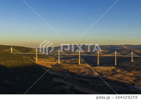 Multi-span cable stayed Millau Viaduct across gorge valley of Tarn River, Aveyron Departement, France Multi-span cable stayed Millau Viaduct across gorge valley of Tarn River, Aveyron Departement, France 104329259