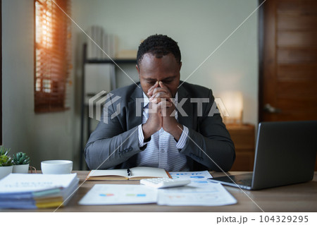 Burnout American African business man in stress works with many paperwork document, migraine attack, Freelance, work from home. Burnout American African business man in stress works with many paperwork document, migraine attack, Freelance, work from home. 104329295