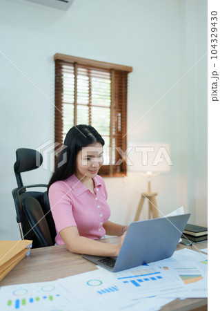 financial, Planning, Marketing and Accounting, portrait of Asian employee checking financial statements using documents and calculators at work.. financial, Planning, Marketing and Accounting, portrait of Asian employee checking financial statements using documents and calculators at work.. 104329430