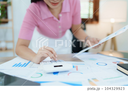 Accountants, Asian auditors are using calculators and computers to review annual tax budgets to submit information to the IRS Accountants, Asian auditors are using calculators and computers to review annual tax budgets to submit information to the IRS 104329923