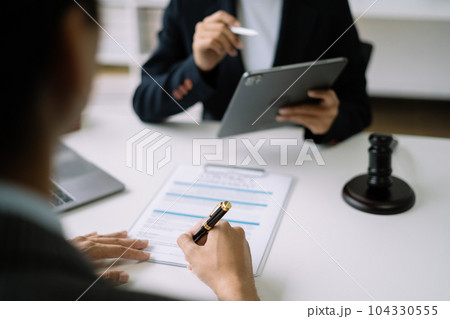 Business people and lawyers discussing contract papers sitting in the table at office in the morning. concepts of law, advice, legal services. 104330555