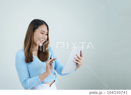 Portrait of asian woman using tablet relaxing at home. 104330741