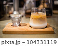 a cup of ice latte coffee and cold water on Wooden tray 104331119