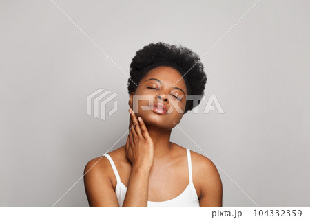 Attractive young woman with clear skin, studio portrait Attractive young woman with clear skin, studio portrait 104332359