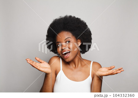 Happy woman presenting with empty open hand holding something blank isolated on white background  104332360