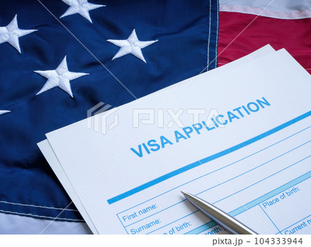 Visa application form on the USA flag. Visa application form on the USA flag. 104333944