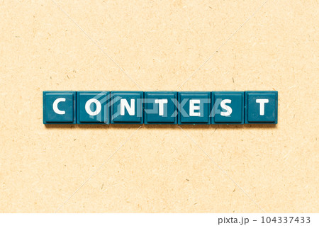 Tile alphabet letter in word contest on wood background 104337433