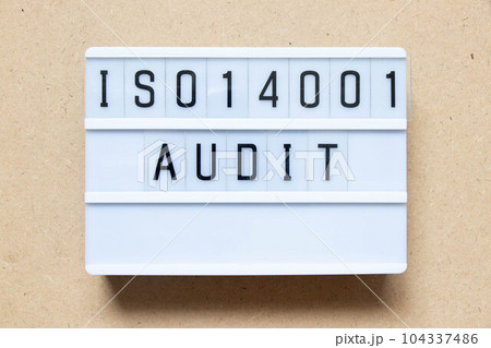 Lightbox with word ISO 14001 audit on wood background Lightbox with word ISO 14001 audit on wood background 104337486