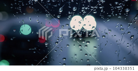 Driving in raining. Rain on car windshield or car window in rainy season and blurry traffic road in background. Rain drops on car mirror. Road in rain. Drizzle raining decreases driving visibility. Driving in raining. Rain on car windshield or car window in rainy season and blurry traffic road in background. Rain drops on car mirror. Road in rain. Drizzle raining decreases driving visibility. 104338351