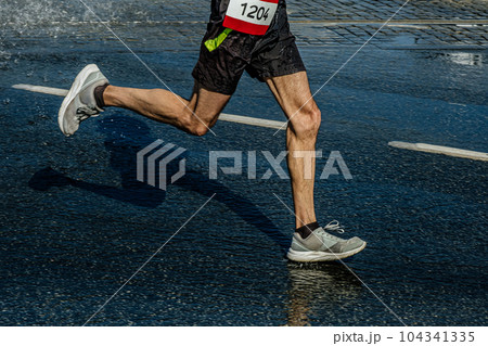 legs male runner running marathon race in puddle, sports summer games legs male runner running marathon race in puddle, sports summer games 104341335