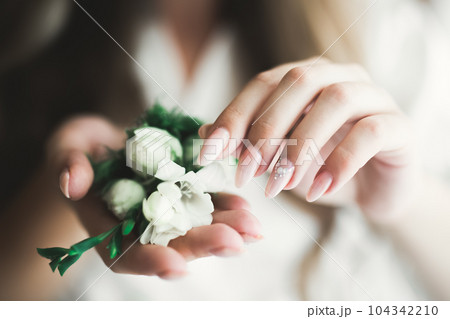 Bride holding big and beautiful wedding bouquet with flowers 104342210