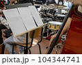 Real life young music students during rehearsals. Musical instruments and music stand with stave. 104344741