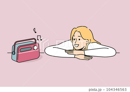 Woman is listening to radio using vintage fm receiver and enjoying analog sound of music 104346563