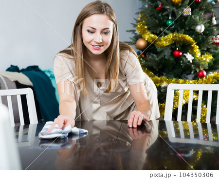 Woman cleaning table before dinner Woman cleaning table before dinner 104350306