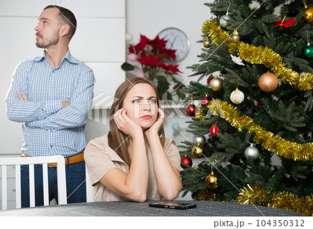 Couple quarreling during Christmas celebration Couple quarreling during Christmas celebration 104350312