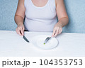 Cropped image of a girl eating peas. weight loss diet. Eating disorder. 104353753
