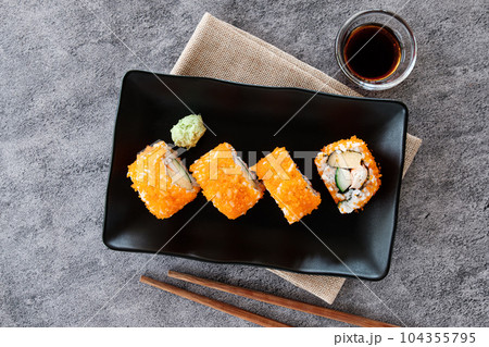 California Maki Japanese food, on black plate, ready to Eat California Maki Japanese food, on black plate, ready to Eat 104355795