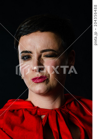 beautiful woman red cloak with red flowers roses in studio. Woman Red Riding Hood. Dramatic and fantastic shooting,fashionable toning. Like a princess 104356488