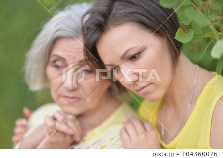 Elderly woman with her daughter walking in summer 104360076