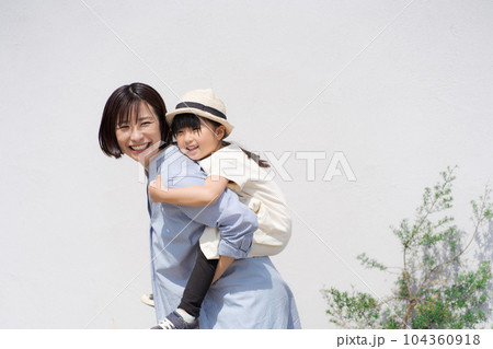 おんぶをする親子の写真 104360918