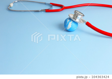 Checking health with red stethoscope on earth. World health day concept - blue earth with on light blue background 104363424