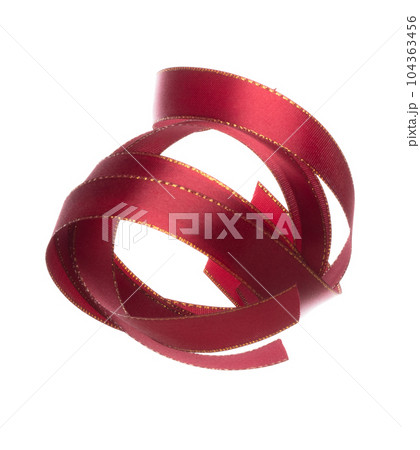 Red ribbon long straight fly in air with curve roll shiny. Red ribbon for present gift birthday party to wrap around decorate and curl curve long straight. White background isolated 104363456