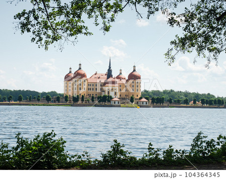 Baroque castle of Moritzburg reflected in a lake and frame Baroque castle of Moritzburg reflected in a lake and frame 104364345
