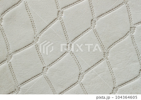 Genuine leather with rhombus embossed pattern. Modern pattern, background Genuine leather with rhombus embossed pattern. Modern pattern, background 104364605