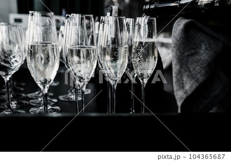 waiter pours wine and champagne 104365687