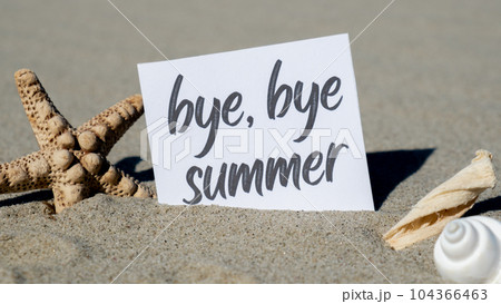 BYE BYE SUMMER text on paper greeting card on background of starfish seashell summer vacation decor. Sandy beach sun coast. Holiday concept postcard. Getting away Travel 104366463
