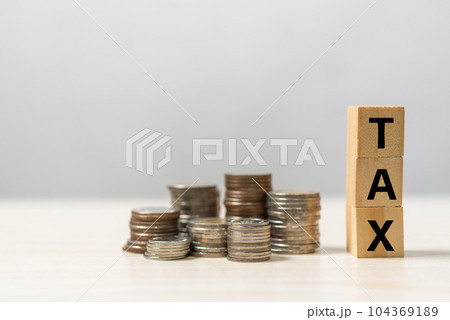 wood cube tax and coin.Saving money and finance banking, accounting business. wood cube tax and coin.Saving money and finance banking, accounting business. 104369189